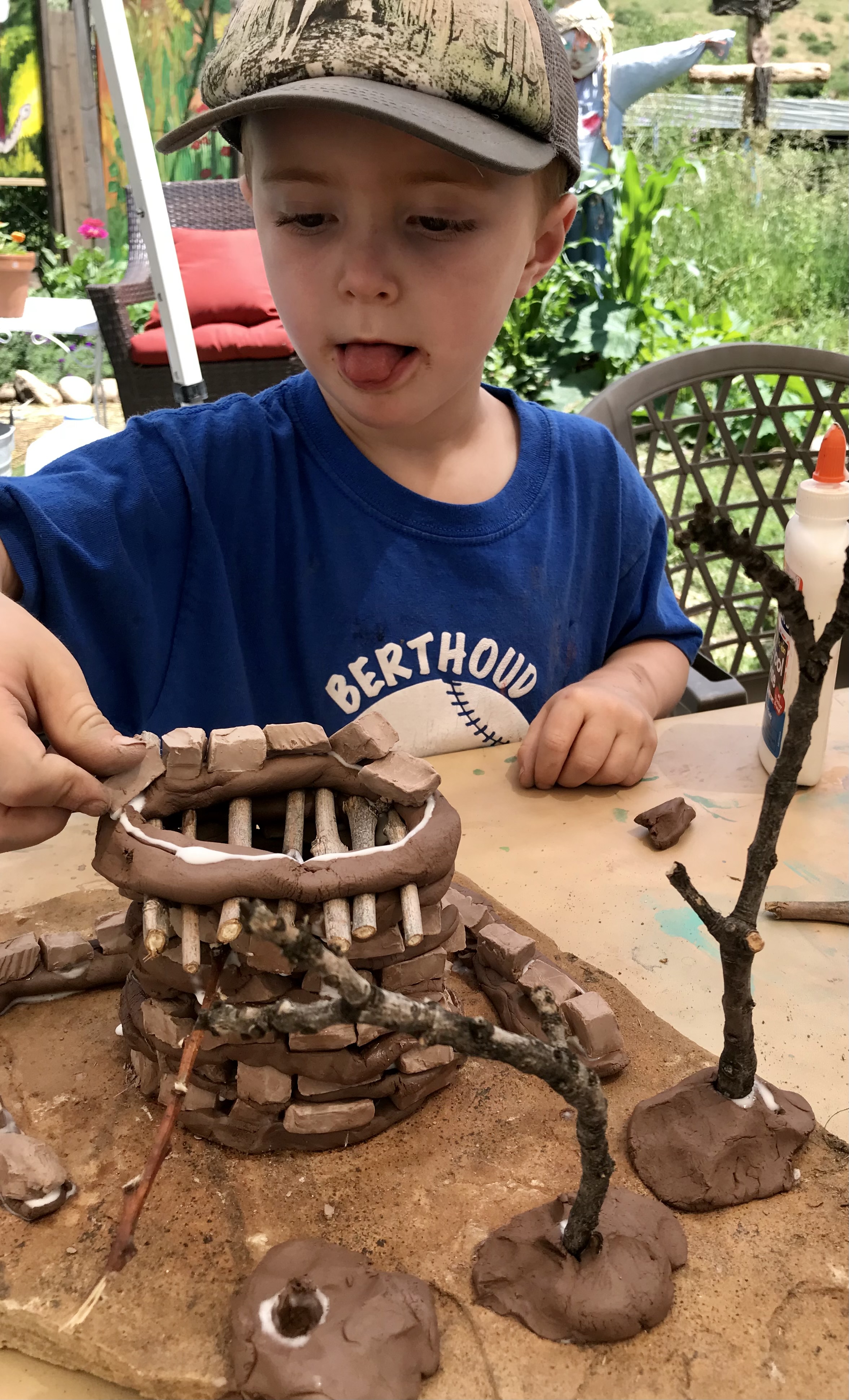 Crafting his clay and stick homestead